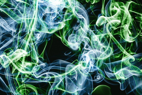 Abstract blue and green smoke on black background