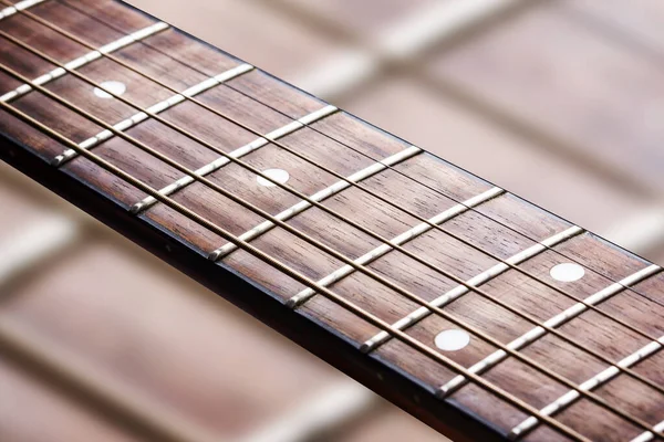 Guitar fret isolated. Music background. Wooden guitar part close up. Guitar strings background.