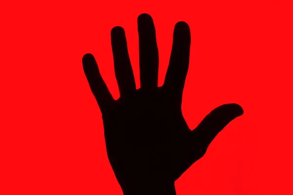 Protest symbol background. Stop hand silhouette. black  hand isolated on red. Warning background. Banned and forbidden symbol.