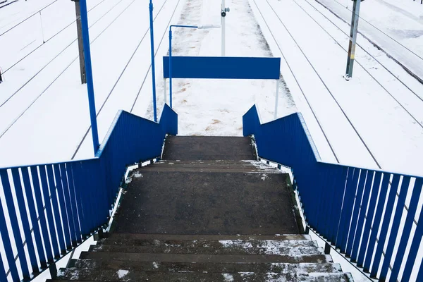 Railway top view background. Train track texture. White transportation background. Winter landscape. Snow on the railway. Icy train plaftorm. Train station covered in snow.