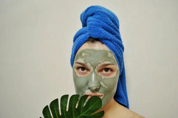 Woman Blue Towel Her Head Clay Mask Her Face Holds — Stock Photo, Image