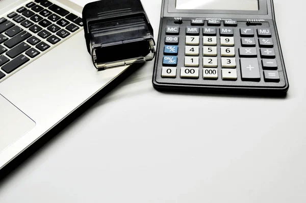Accountant\'s Day. Calculator and print lie on a laptop.