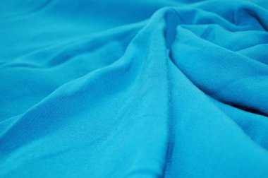 Arka plan olarak mavi tekstil deseni. Kumaştaki mavi kumaş dokusuna yaklaş. Buruşmuş kumaş dokusu