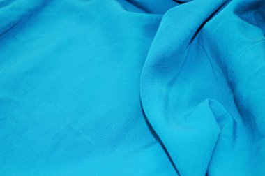 Arka plan olarak mavi tekstil deseni. Kumaştaki mavi kumaş dokusuna yaklaş. Buruşmuş kumaş dokusu