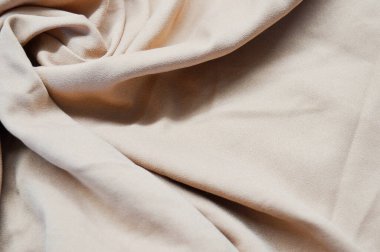 Arka plan olarak açık pembe tekstil deseni. Açık pembe kumaşın kumaş dokusunu kapatın. Buruşmuş kumaş dokusu