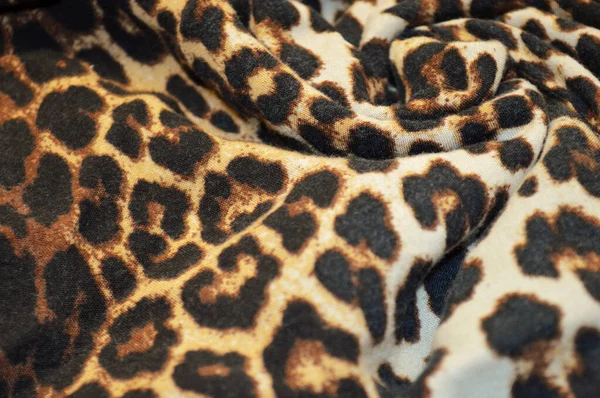 Leopard print textile as a background. Close up on Leopard print material texture on fabric. crumpled fabric texture