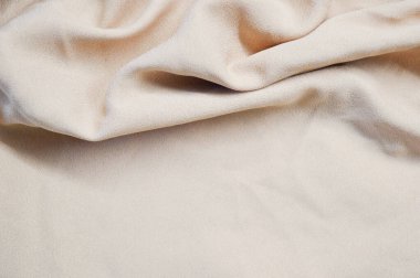 Arka plan olarak açık pembe tekstil deseni. Açık pembe kumaşın kumaş dokusunu kapatın. Buruşmuş kumaş dokusu