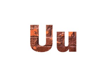 Kahverengi desenli tuğla duvar. U harfinin kesik siluetini delip geçmiş.