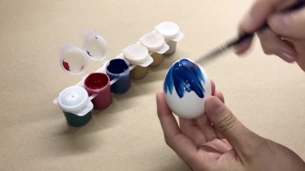 女人的手用刷子把鸡蛋涂成蓝色 — 图库视频影像