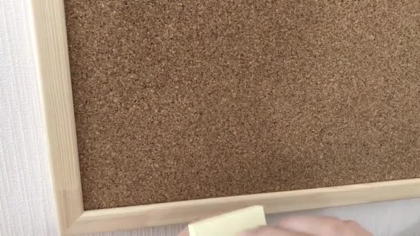 Young Woman Sticks Yellow Note Paper Cork Board — Αρχείο Βίντεο