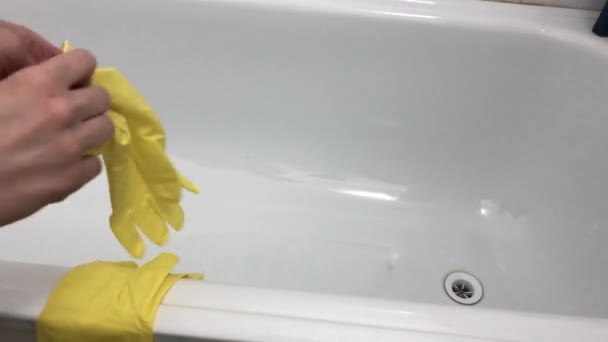 Young Woman Puts Orange Rubber Household Gloves Background Bath Cleaning — Vídeo de stock
