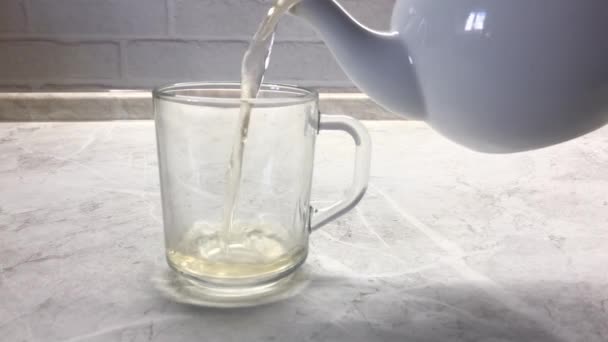 Woman Pouring Green Tea White Porcelain Teapot Glass Transparent Glass — Wideo stockowe