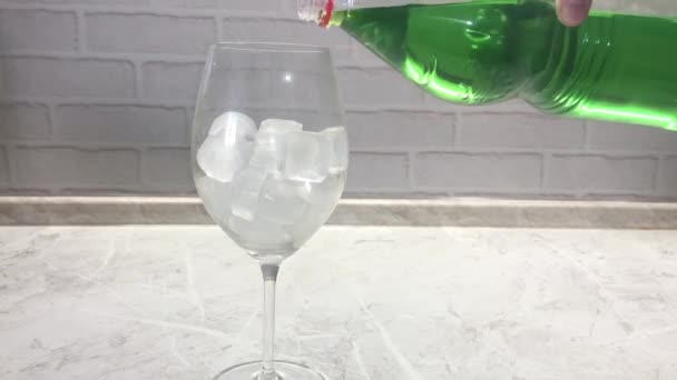 Woman Pouring Green Lemonade Bottle Glass Goblet Ice Kitchen — Stockvideo