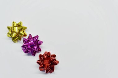 Kopya alanı olan beyaz bir arkaplanda hediyeler için üç parlak fiyonk seti.