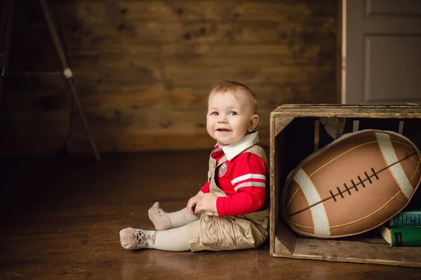 Portrait of cute happy 8 month old baby boy with american footba — Stock Photo, Image