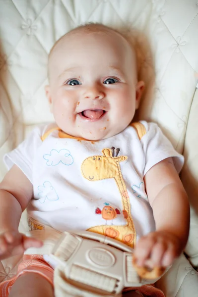 Laughing eating baby girl with dirty face — Stock Photo, Image