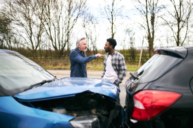 Aggressive senior male driver arguing over blame for car accident with a younger male motorist clipart