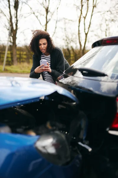 女性ドライバー保険金請求のための携帯電話で道路交通事故の写真を撮る — ストック写真