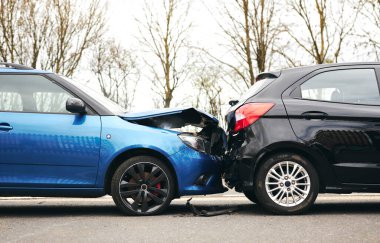 Two cars involved in traffic accident on side of the road with damage to bonnet and fender clipart