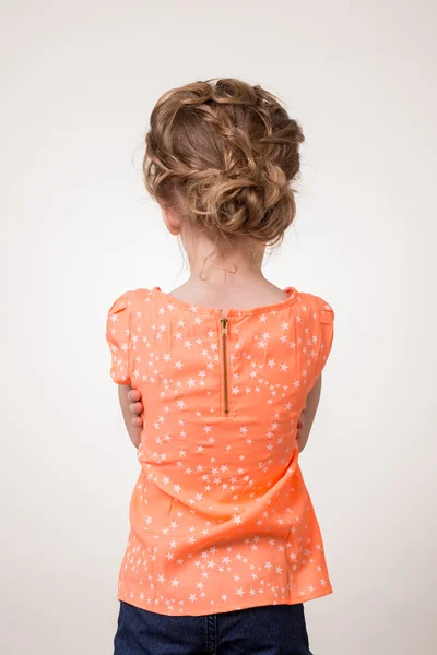 Back view standing young beautiful  teen girl looks forward placing hugging her arms. Isolated over white background — Stock Photo, Image