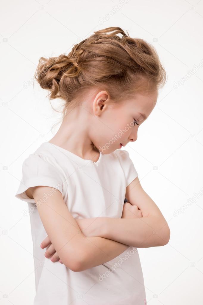 Cute teen girl angry frowns, studio portrait isolated on white background