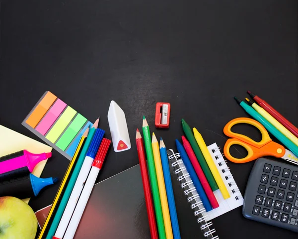 School supplies on blackboard background — Stock Photo, Image