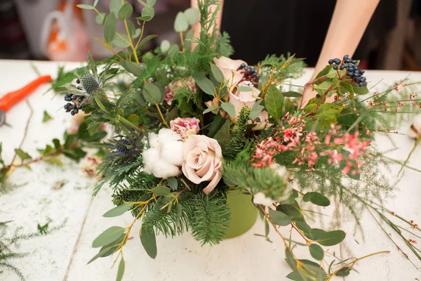 Creating a wonderful composition cotton, cones, fir, magical variety carnations and delicious varieties of roses. Handmade — Stock Photo, Image