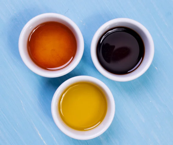 zeytin yağı, soya sosu, susam yağı ahşap bir masa üzerinde duran