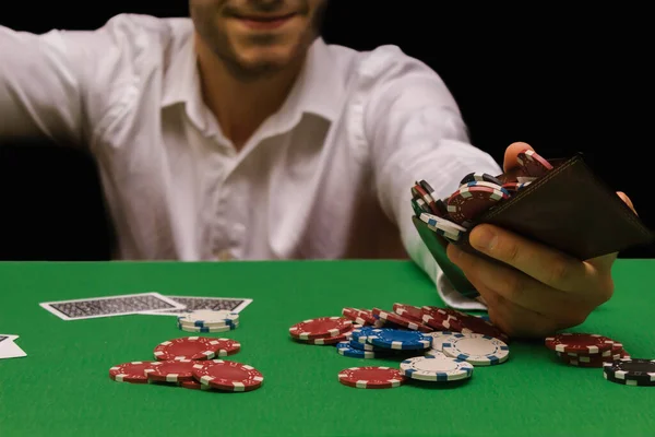 Person in a night casino playing poker, gambling money with chips. black background with copy space. concept of gambling, winning, losing, fun, wealth, triumph