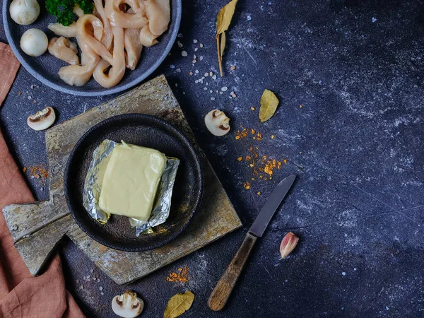 Chicken fillet and melted cheese in a plate on the left against a dark cement background with space for text on the right, top view close-up. — Stock Image Chicken Fillet Melted Cheese Plate Left Dark Cement Background Space Royalty Free Stock Photos