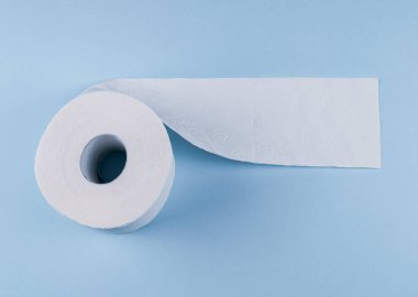 Mavi arka planda bir rulo tuvalet kağıdı, en üstteki yakın plan. .