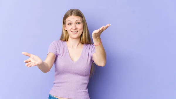 Young Blonde Woman Isolated Purple Background Makes Scale Arms Feels — Stock Photo, Image