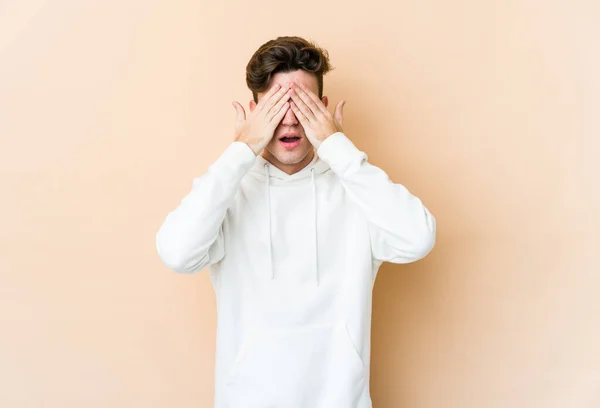 Young Caucasian Man Isolated Beige Background Afraid Covering Eyes Hands — Stock Photo, Image