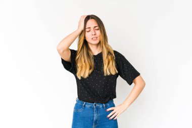 Beyaz arka planda izole edilmiş genç beyaz kadın yorgun ve uykulu ellerini başının üstünde tutuyor..