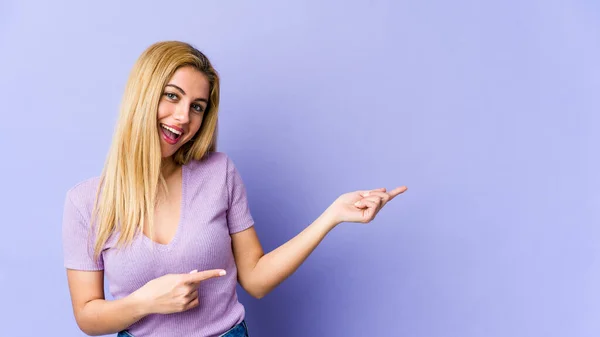 Young Blonde Caucasian Woman Smiling Cheerfully Pointing Forefinger Away — Stock Photo, Image