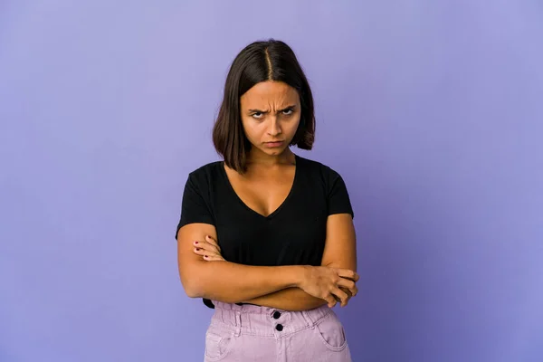 Young mixed race woman frowning face in displeasure, keeps arms folded.