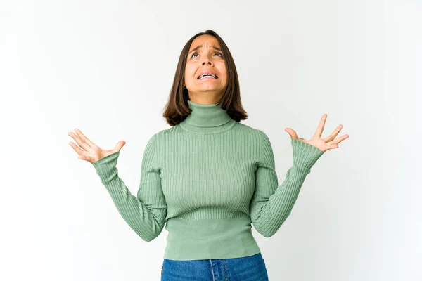 Young mixed race woman screaming to the sky, looking up, frustrated.