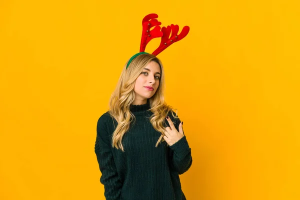Young Blonde Caucasian Woman Wearing Reindeer Horns Pointing Finger You — ストック写真