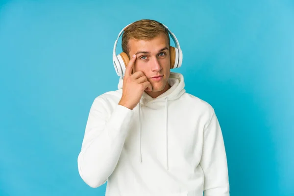 Young Caucasian Man Listening Music Isolated Blue Background Trying Listening — Stock Photo, Image