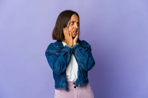 Young mixed race woman scared and afraid.