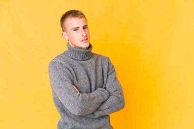 Kendine güveni tam, kararlılığıyla kollarını kavuşturan beyaz tenli yakışıklı bir adam..