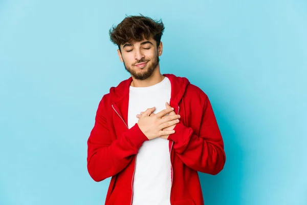 Hombre Árabe Joven Sobre Fondo Azul Tiene Expresión Amistosa Presionando — Foto de Stock