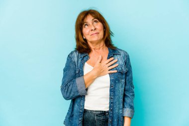 Kafkasyalı kıdemli kadın kahkahalarla gülüyor ve elini göğsüne koyuyor..