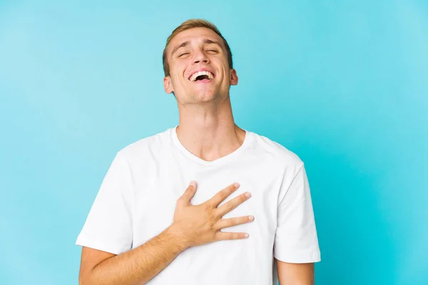Young Caucasian Handsome Man Laughs Out Loudly Keeping Hand Chest — Stock Photo, Image