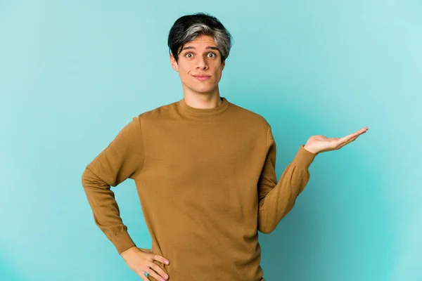 Young skinny hispanic man posing on color background