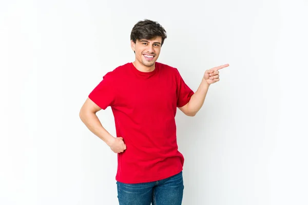 Young Cool Man Smiling Cheerfully Pointing Forefinger Away — Stock Photo, Image