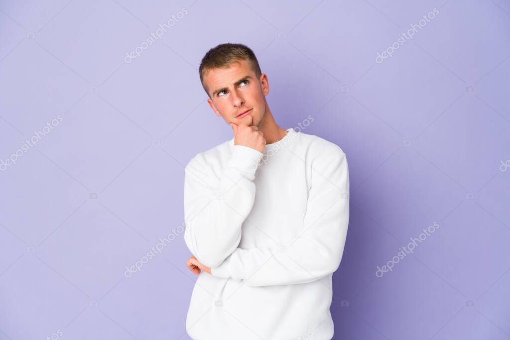 Young caucasian handsome man relaxed thinking about something looking at a copy space.