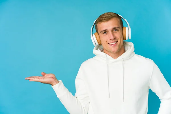 Jeune Homme Caucasien Écoutant Musique Isolée Sur Fond Bleu Montrant — Photo