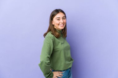 Genç beyaz kadın kendine güveniyor, ellerini kalçasında tutuyor..