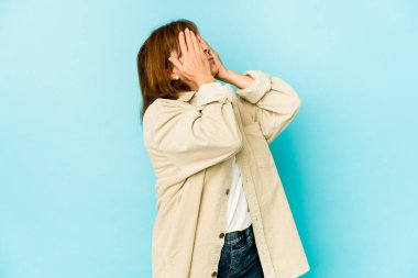 Üst düzey beyaz kadın izole edilmiş. Gözleri elleriyle kapatmaktan korkuyor..